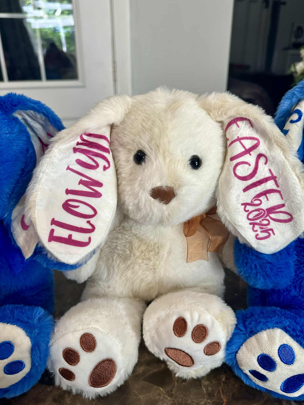Plush bunny with personalized ears in a room setting