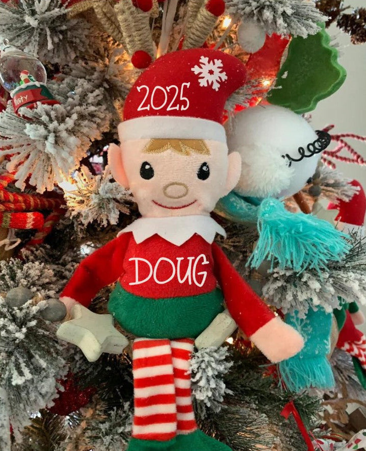 Elf doll with '2025' and 'Doug' on a decorated Christmas tree