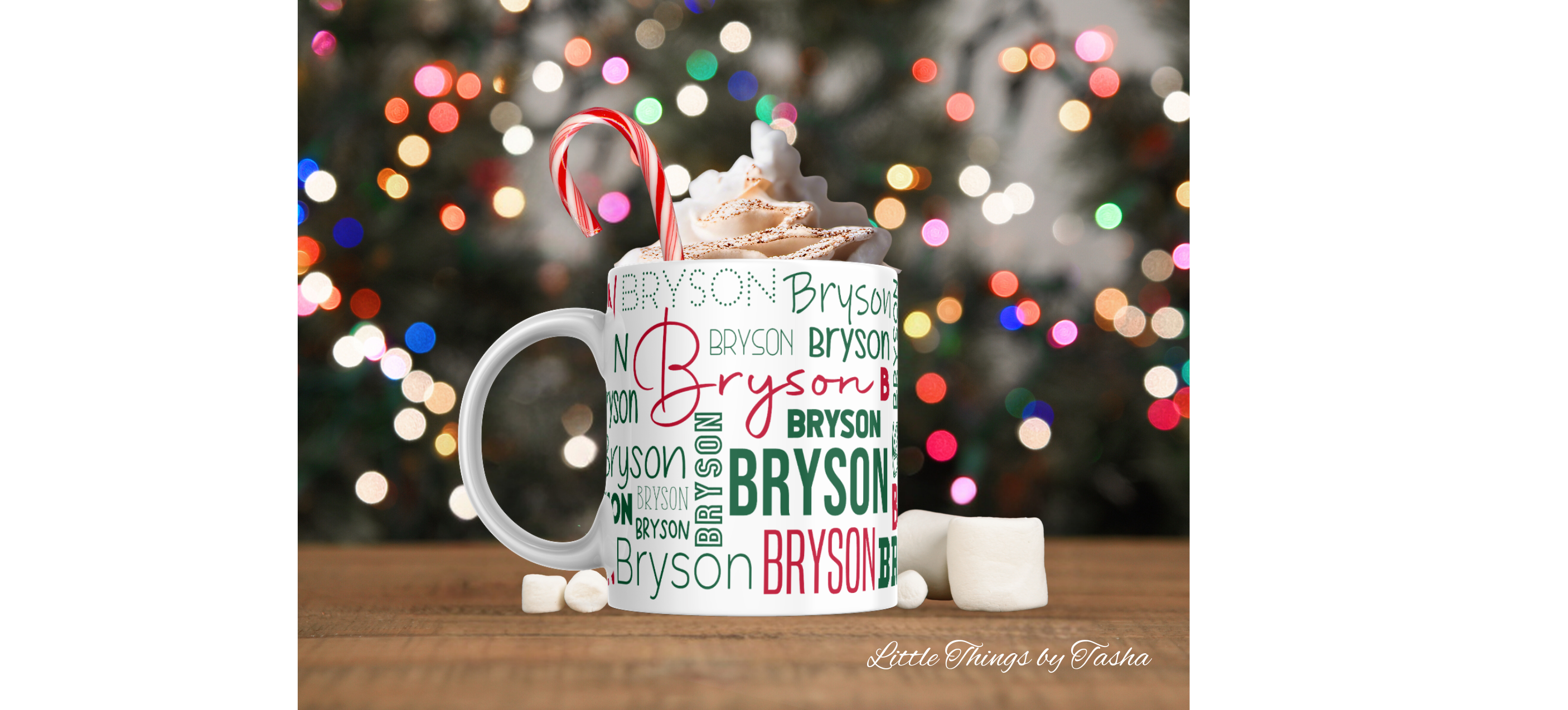 Personalized mug with 'Bryson' pattern, hot chocolate, and candy canes against a blurred Christmas tree background.