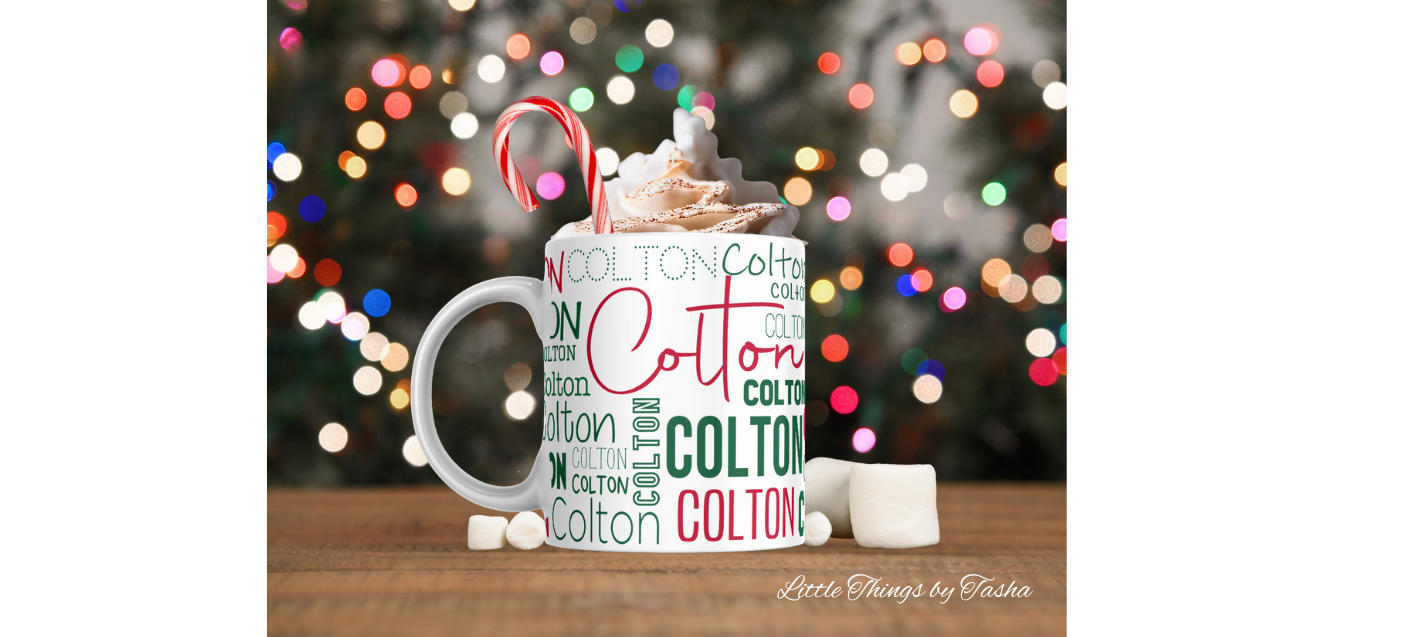 Mug with 'Colton' branding filled with hot chocolate and candy canes against a blurred Christmas lights background.