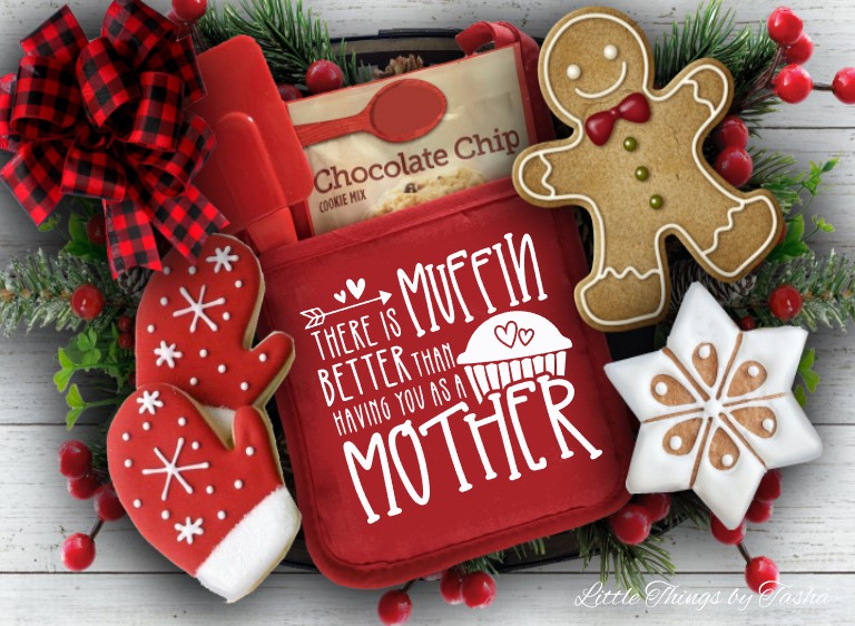 Red cookie press with gingerbread-themed cookies and decorative elements on a wooden surface.